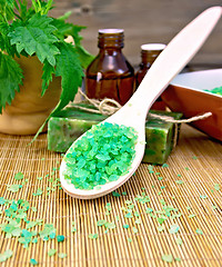 Image showing Salt and oil with nettles in mortar on board