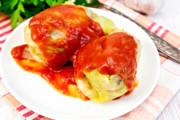 Image showing Cabbage stuffed with sauce in plate on board