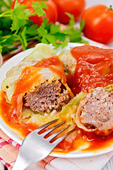 Image showing Cabbage stuffed with fork in plate on board