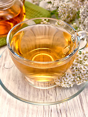 Image showing Tea with yarrow in glass cup on board