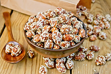 Image showing Peanuts in caramel with sesame on board