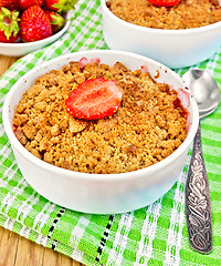 Image showing Crumble strawberry on green napkin with spoon