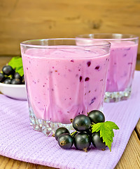 Image showing Milkshake with blackcurrants on napkin and board