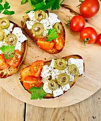 Image showing Sandwich with feta and olives on table