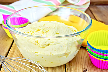 Image showing Dough for cupcakes with molds on board