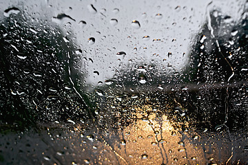 Image showing Raindrops with yellow car headlights