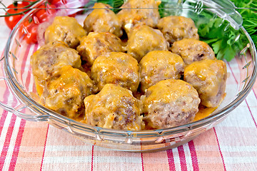 Image showing Meatballs with sauce in glass pan on linen tablecloth