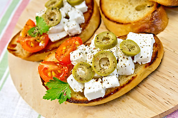 Image showing Sandwich with feta and olives on napkin