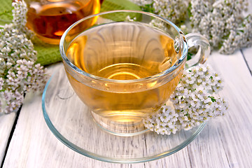 Image showing Tea with yarrow in glass cup on light board