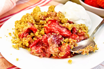 Image showing Crumble strawberry in plate with spoon on napkin