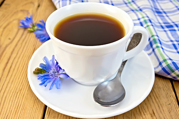 Image showing Chicory drink in white cup with flower and napkin on board