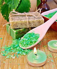 Image showing Salt and candles with nettles in mortar on board