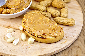 Image showing Sandwich with peanut butter and nuts on board
