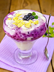 Image showing Dessert milk with blueberries on purple napkin