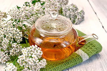 Image showing Tea with yarrow in glass teapot on napkin