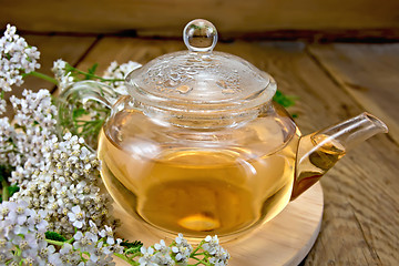 Image showing Tea with yarrow in glass teapot on board