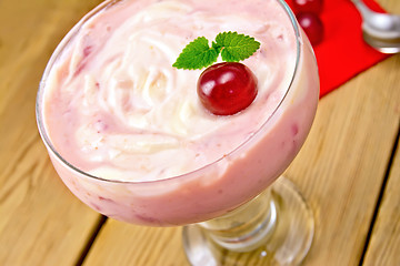 Image showing Dessert milk with cherry and red napkin