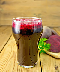 Image showing Juice beet in tall glass on board