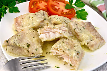 Image showing Fish stew with cream sauce in plate on board