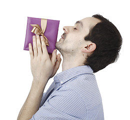 Image showing Young man holding a present