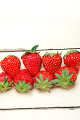 Image showing fresh organic strawberry over white wood