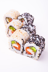 Image showing salmon sushi roll in sesame seeds 