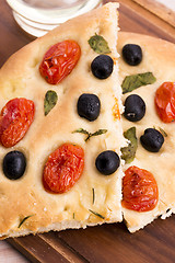 Image showing Focaccia with black olives, tomatoes and basil