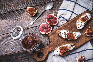 Image showing Tasty Bruschetta snacks with figs on napkin in rustic style