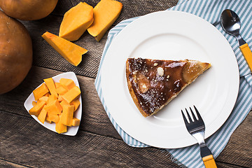 Image showing pieces of pumpkin and pie on plate on wood