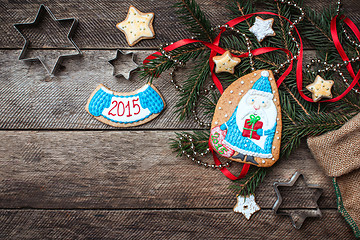Image showing Cute Santa and New Year star cookies in rustic style on wood