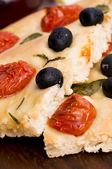 Image showing Focaccia with black olives, tomatoes and basil