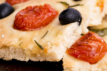 Image showing Focaccia with black olives, tomatoes and basil