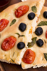 Image showing Focaccia with black olives, tomatoes and basil