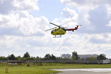 Image showing The small yellow helicopter of Utair airline in the sky.