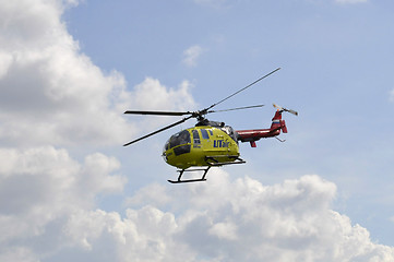 Image showing The small yellow helicopter of Utair airline in the sky.