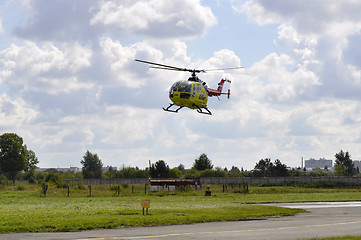 Image showing The small yellow helicopter of Utair airline in the sky.