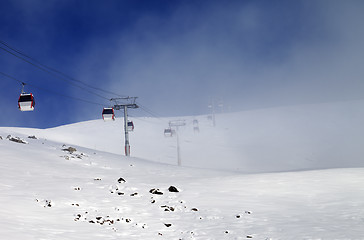 Image showing Gondola lifts and ski slope in mist