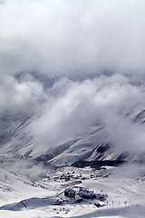 Image showing Top view on ski slope and hotels in mist