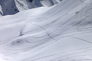 Image showing Top view on snowy off piste slope with trace from ski and snowbo