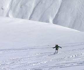 Image showing Snowboarder downhill on off piste slope with newly fallen snow