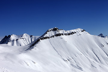 Image showing Off-piste slope in sun day and traces of avalanches