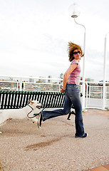 Image showing woman running with dog