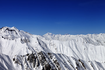 Image showing Snowy mountains in sun day