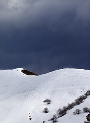 Image showing Off-piste slope and overcast gray sky in windy day