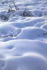 Image showing Snow drifts in snowbound winter meadow 