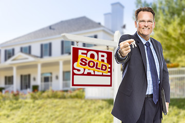 Image showing Agent with Keys in Front of Sold Sign and House