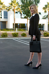 Image showing Business woman standing in parking lot