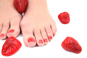 Image showing women feet (pedicure) with  strawberries