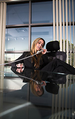 Image showing sitting at her desk