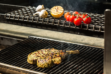 Image showing steak flame broiled on a barbecue